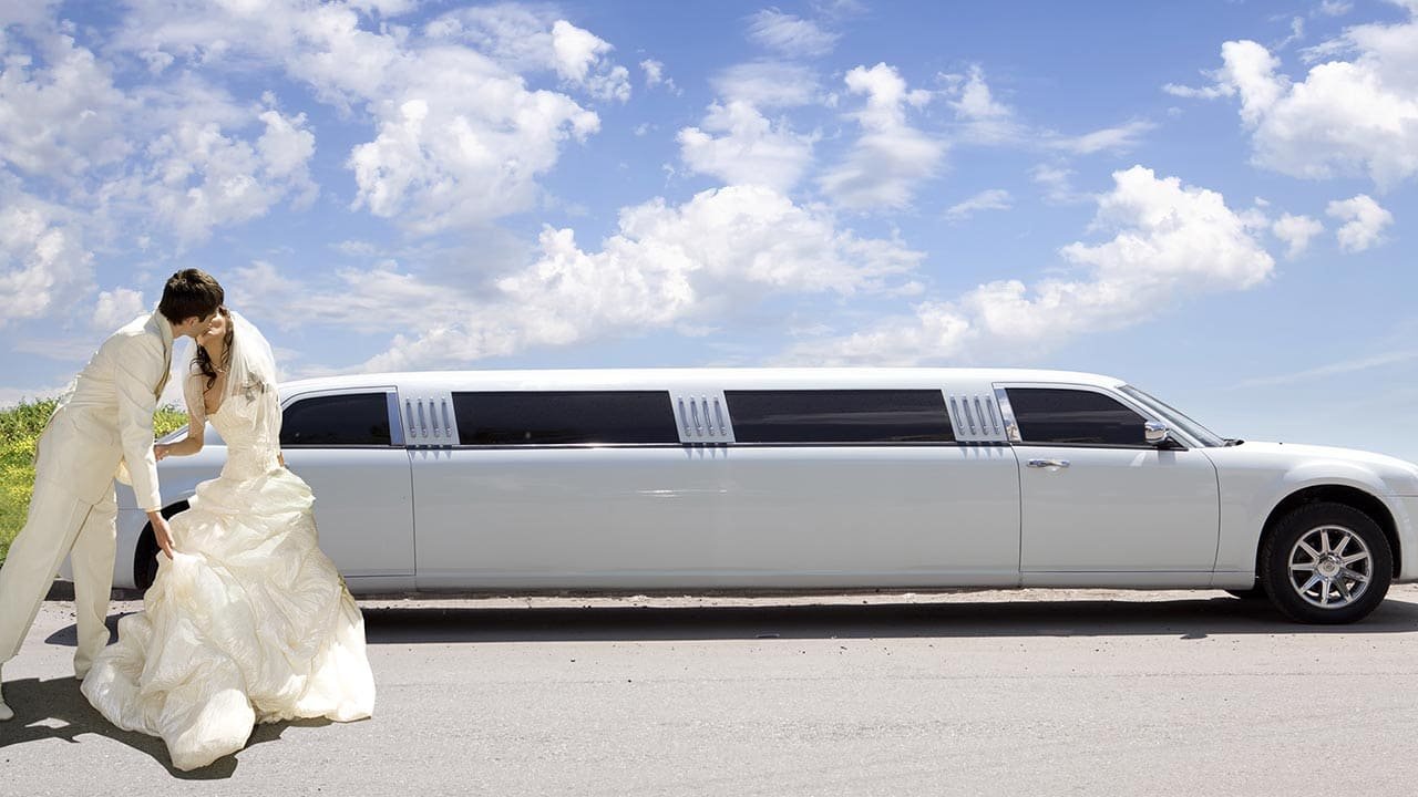 A Universal Limousine luxury transportation vehicle parked outside upscale venue during evening event